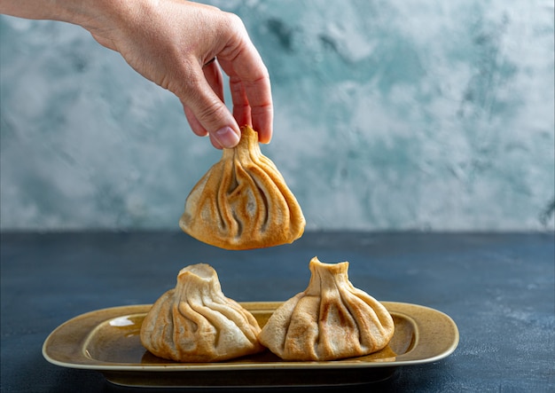 Khinkali, Georgian dumplings, traditional Georgian cuisine. Khinkali on a plate side view.