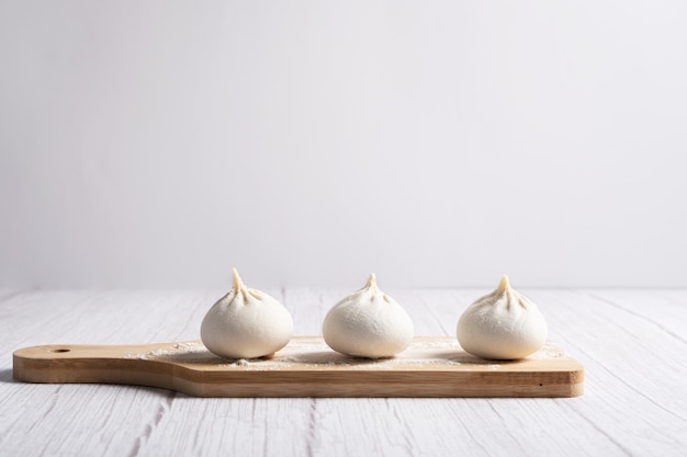 Khinkali Georgian dumplings on a wooden board.