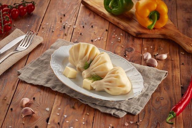 Khinkali with meat, Georgian cuisine, wooden background