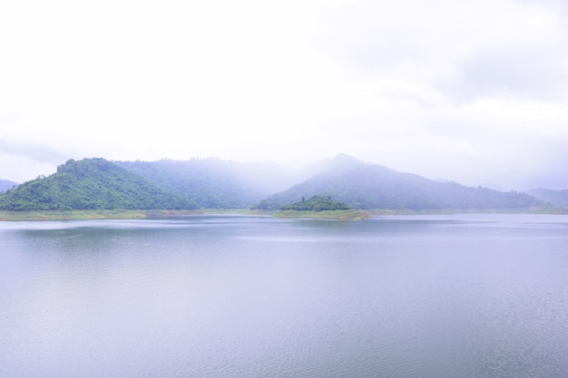 Khun Dan Prakan Chon Dam in Nakon Nayok with fog and clouds on rainy Day.