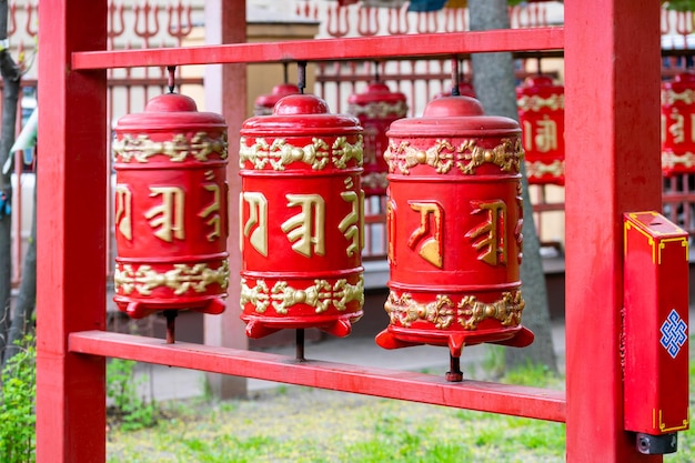 Khurde red prayer drums with mantras on the street near the Buddhist temple of the Buryat datsan