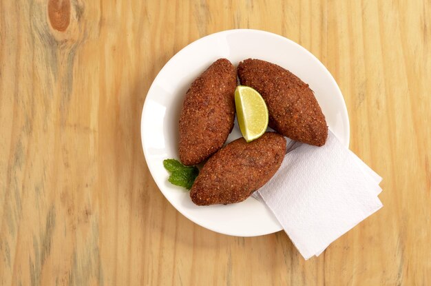 kibes served on the table with lemon slice