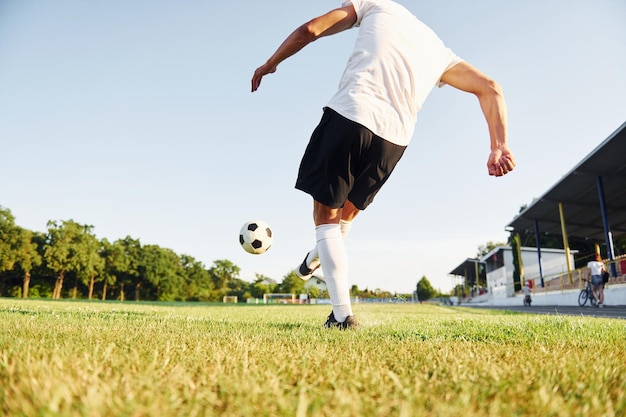 Kicks the ball Young soccer player have training on the sportive field