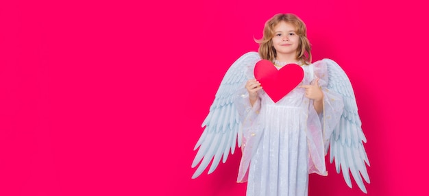 Kid angel with heart symbol love and valentines day child angel pointing on heart point gesture vale