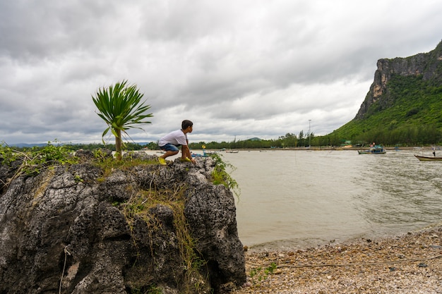 Kid boy standing on the rocks at Khao Ta Mong Lai Forest Park,Prachuap Khiri Khan.