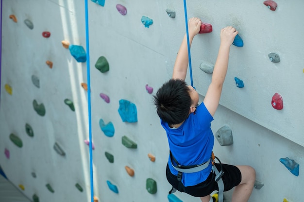 kid climbing a wall, children rock climbing