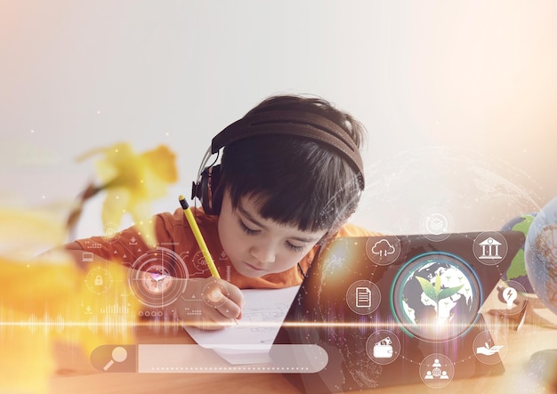 Kid drawing on paper and using tablet research on internet about world populationEcology or EnvironmentalSchool Boy doing online learningGeography with Double exposure growth leaf on globe map