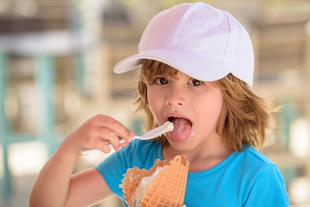 Kid eating ice cream cute child licking big icecream in waffles cone