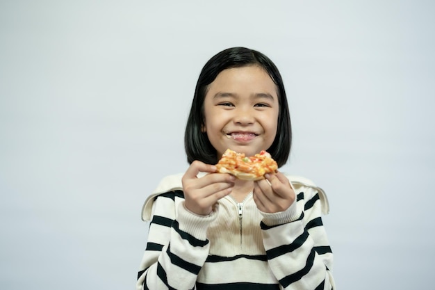 Kid eating pizza on white background