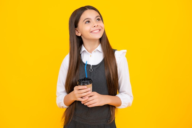 Kid girl 12 13 14 years old with take away cup of cappuccino coffee or tea Child with takeaway mug on yellow background morning drink beverage