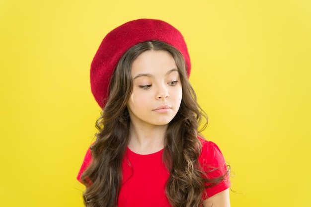 Kid girl long healthy shiny hair Perfect curls Kid cute face with adorable curly hairstyle wear beret hat Little fashionista Little girl grow long hair Styling of curly hair Hairdresser service