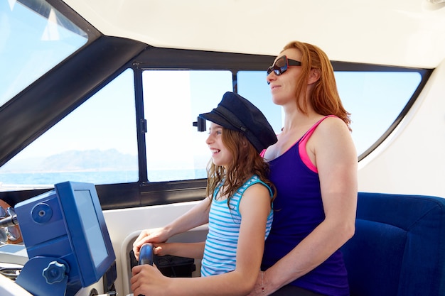 Kid girl pretending be a sailor with her mother