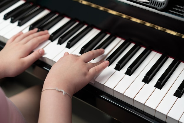 Kid hands play piano key