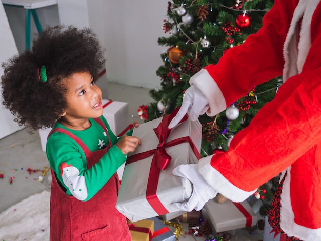 Kid happy to receive gifts from Santa Claus