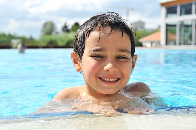 Kid having happy time in the pool water