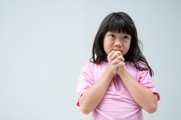 Kid is praying hands folded in prayerxA