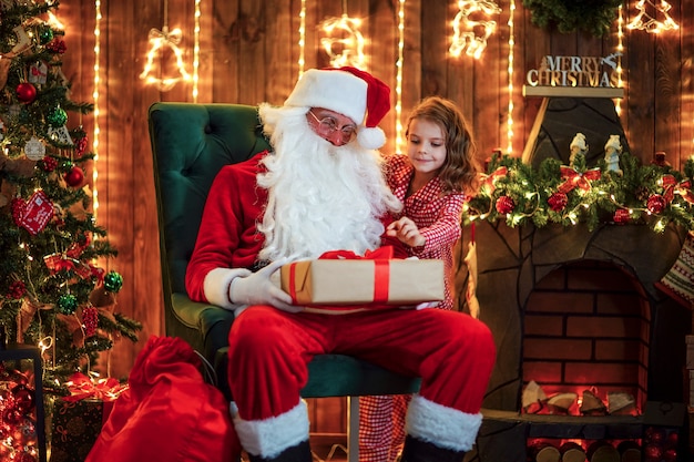 Kid peeping from behind santa claus