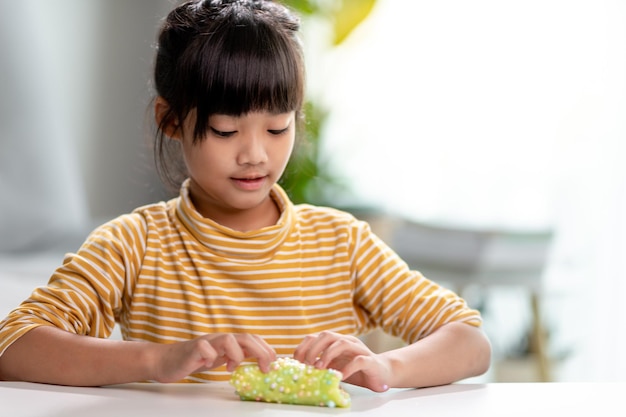 Kid play with handgum Slime in children hands