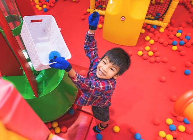 Kid playing with ball cannon