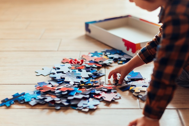 Kid playing with jigsaw