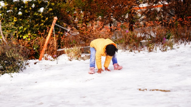 A kid playing with snow