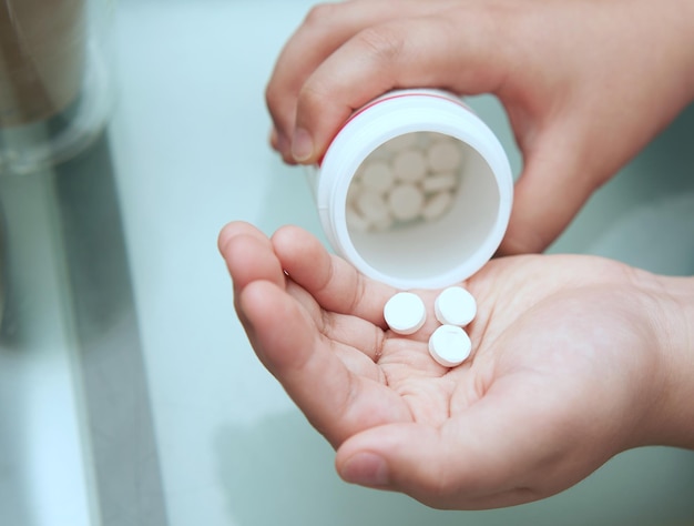 Kid pour pills into palm hand