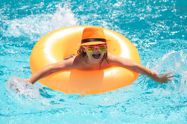 Kid relax on the beach or pool child swim with float ring on summer vacation holidays