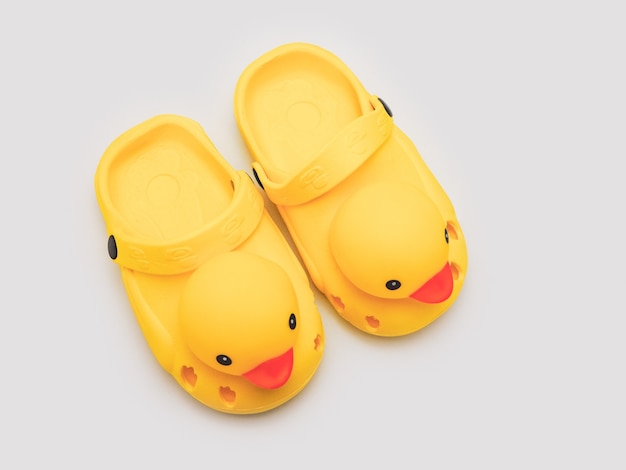 Kid's yellow duck shoes isolate on white background