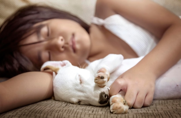 Kid sleep with puppy dog in relation