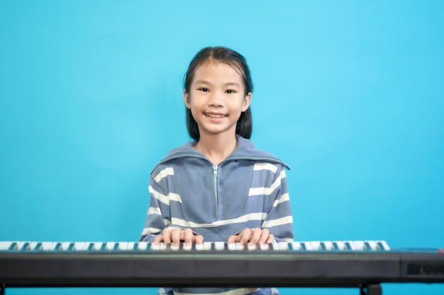 Kid smart and curious, children close up photo of cute and cheerful people, playing piano to music