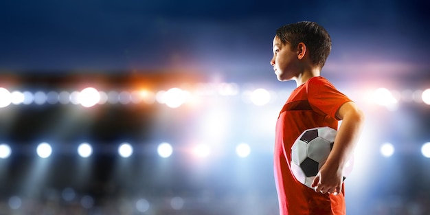 Kid on a soccer stadium. Mixed media