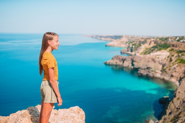 Kid on vacation on white rock background