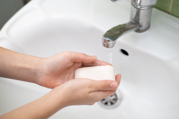 Kid washing hands in the bathroom