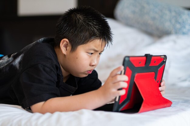 Kid watching tablet boy addicted cartoon