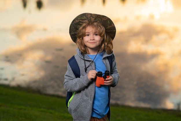 Kid with binoculars hiking at nature little explorer outdoor recreation and adventures with kids chi