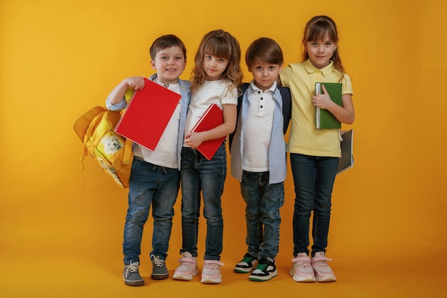 Kids are together against yellow background