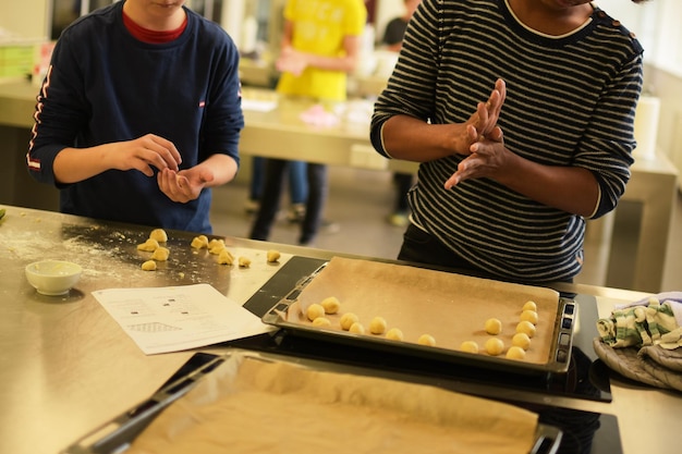 Kids baking cookies in school home ed class