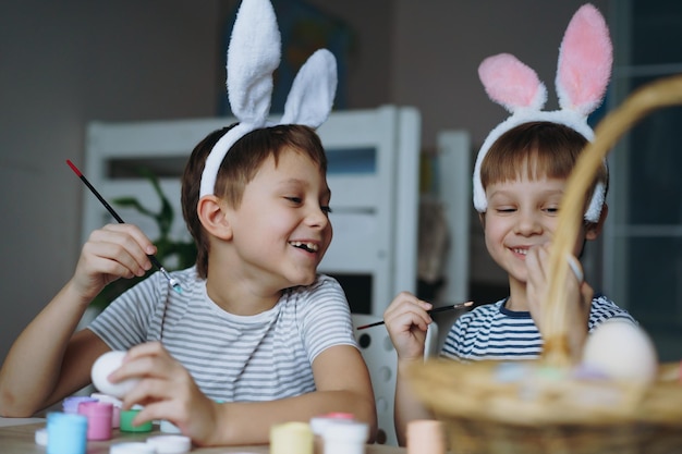 kids colouring eggs for easter Image with selective focus