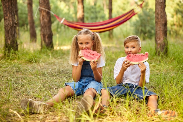 Kids eating watermelon in the park