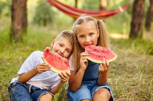 Kids eating watermelon in the park