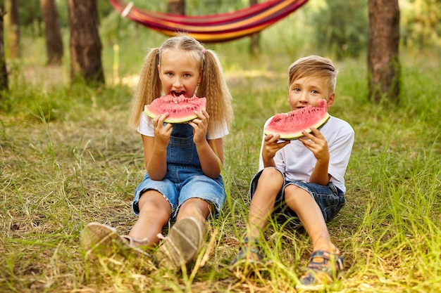 Kids eating watermelon in the park