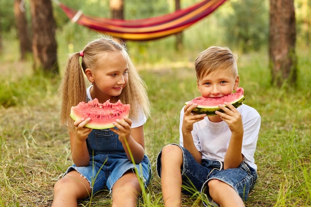 Kids eating watermelon in the park