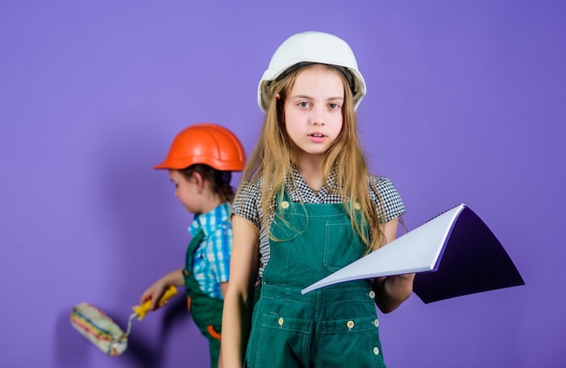 Kids girls planning renovation Repaint walls Move in new apartment Children sisters run renovation their room Control renovation process Sisters happy renovating home Home improvement activity