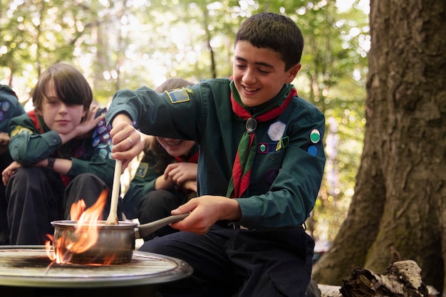 Photo kids having fun as boy scouts