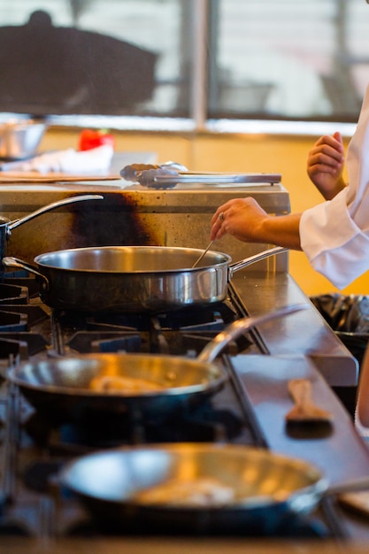 Kids learning how to cook in a cooking class.