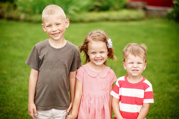 Kids outdoors in summer on the grass in the backyard