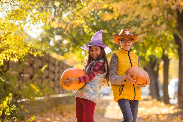 Kids picking and carving pumpkins at country farm