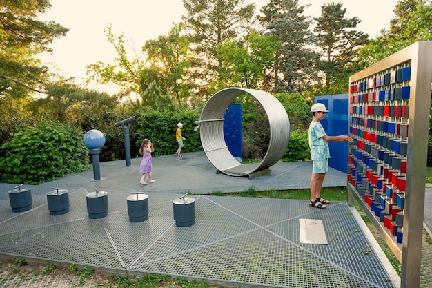 Kids play with telescopes and other stuff at observatory park in planetarium