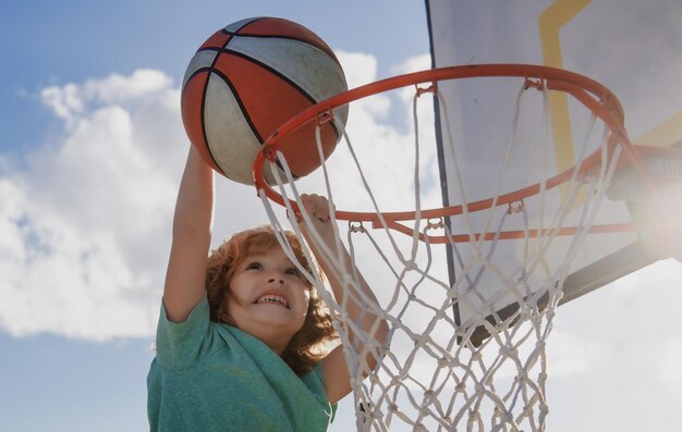 Kids playing basketball child sport activity healthy children lifestyle closeup face of kid basketba