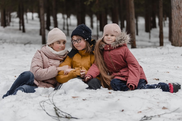 Kids playing in snow Children play outdoors in winter snowfall